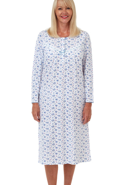 Marlon Jessica blue floral print 100% soft cotton jersey classic traditional nightdress with long sleeves, short placket, gathers from the yoke seams and ribbon slot trim. Photograph on model